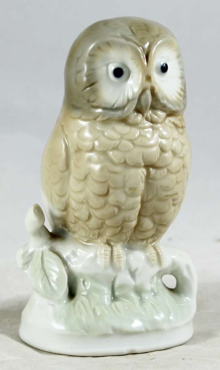 Porcelain owl on tree stump