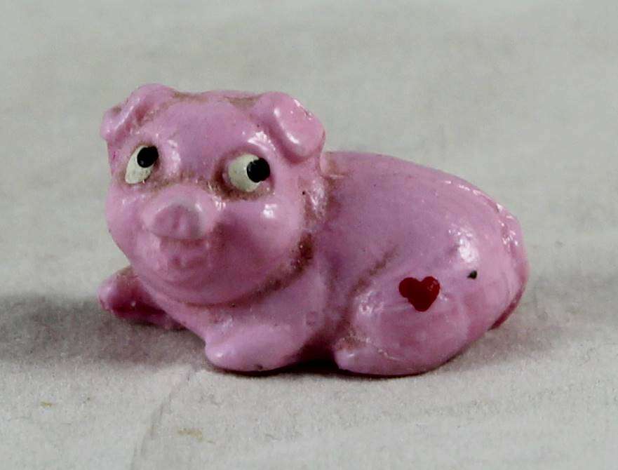 Miniature pink pig - laying down with heart