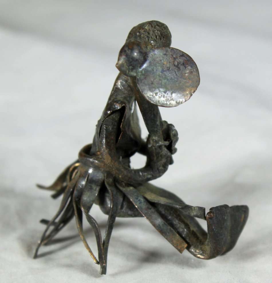 Miniature metal man with hoe