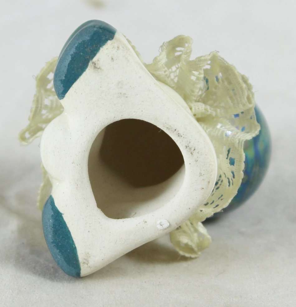 Small porcelain baby with lace collar - green pearl