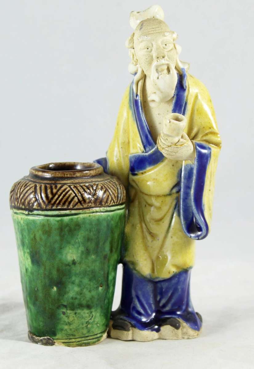 Mud man with big green pot