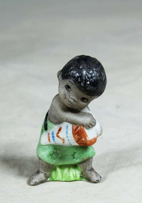 Miniature boy with an African drum