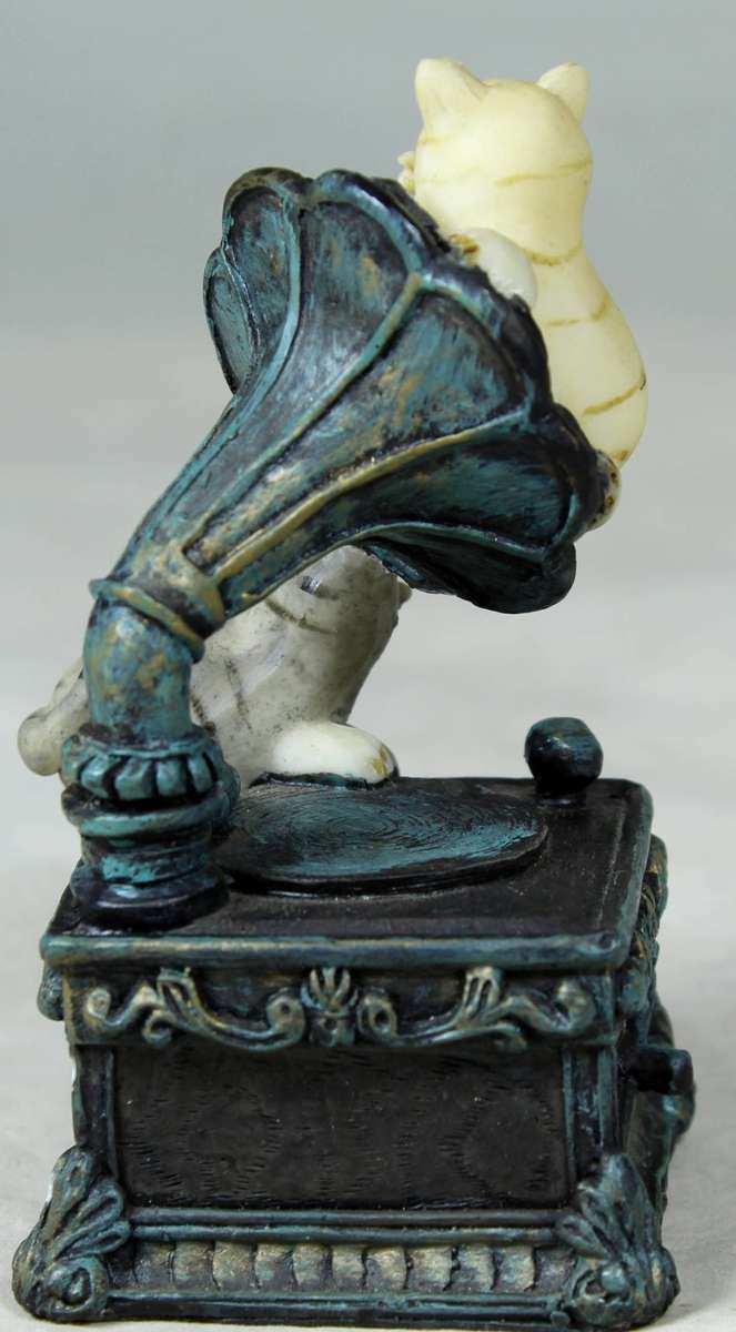 Cats playing on an old gramophone