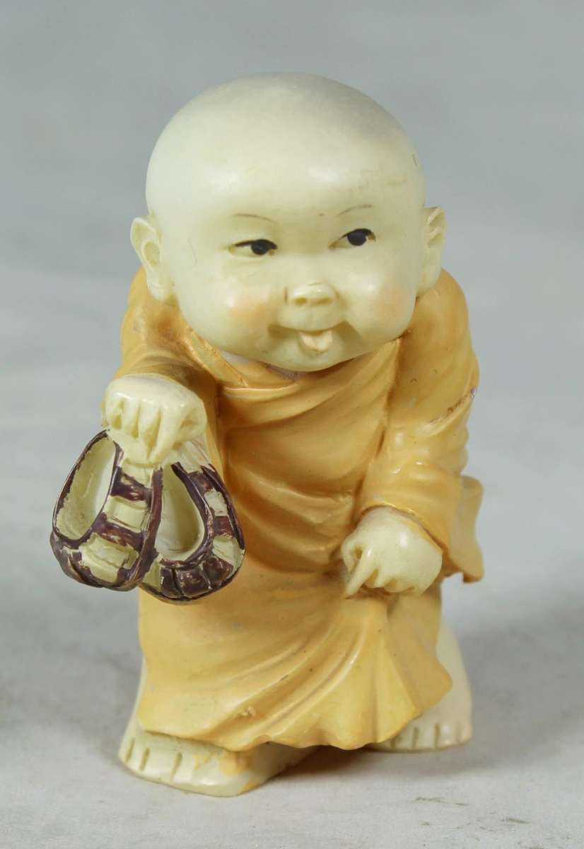 Baby Buddha - Carrying his Shoes and Sticking his Tongue Out