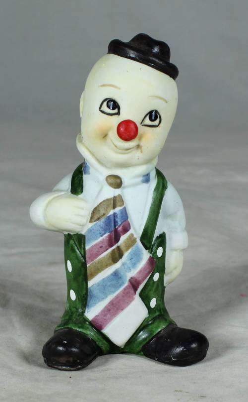 Ceramic clown in a green polka dot jump suit and tie