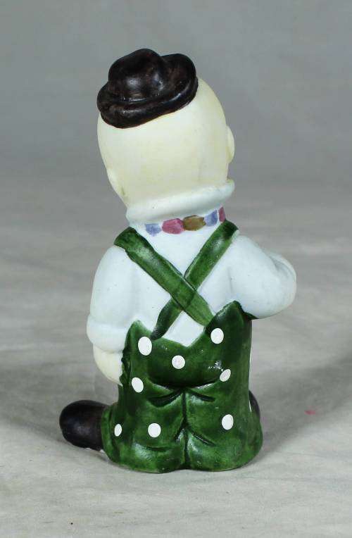 Ceramic clown in a green polka dot jump suit and tie
