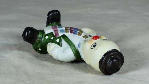 Ceramic clown in a green polka dot jump suit and tie