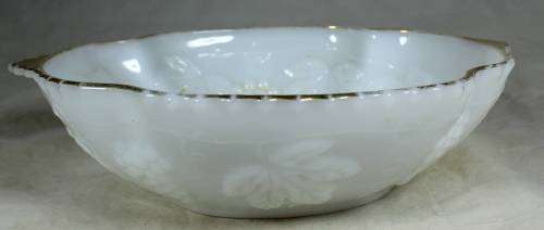 Milk glass bowl with grapes and a gold rim