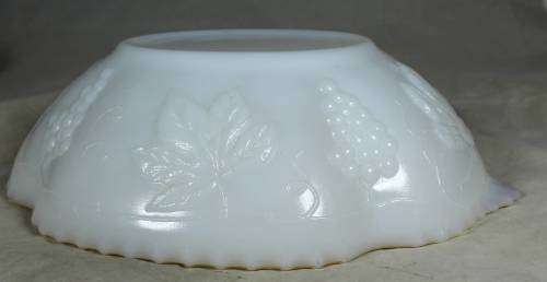Milk glass bowl with grapes and a gold rim