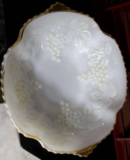 Milk glass bowl with grapes and a gold rim