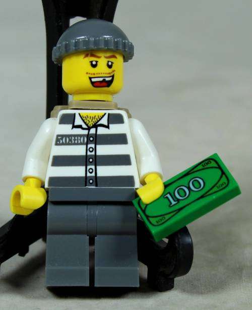 Miniature Lego figurine - Criminal with backpack and bank note