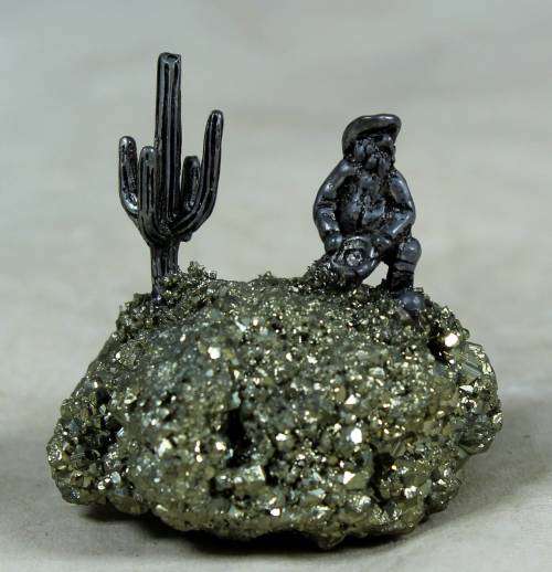 Miniature cowboy on a semi-precious rock