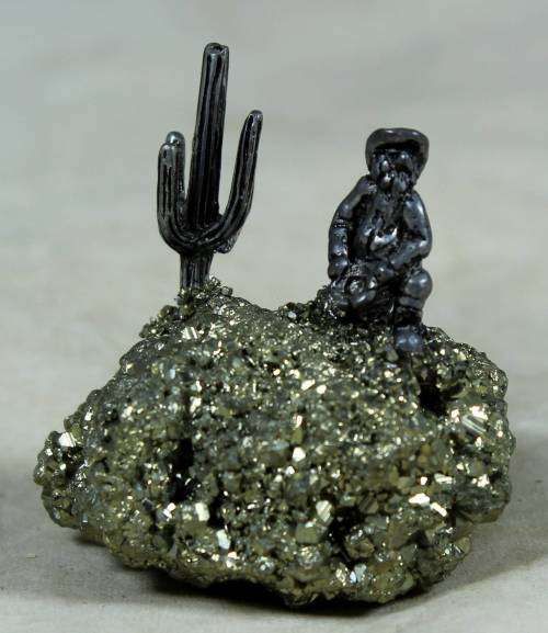Miniature cowboy on a semi-precious rock