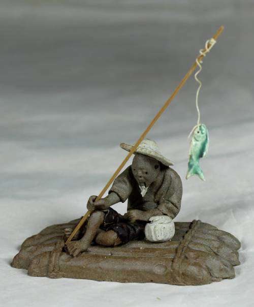 Mud Men - Man on a raft with a fish