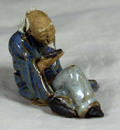 Mud Men - Seated man reading