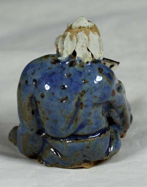 Mud Men - Seated man reading