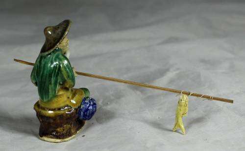 Mud Men - Old man seated & fishing in a brown hat