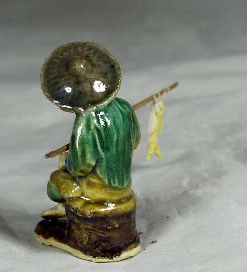 Mud Men - Old man seated & fishing in a brown hat