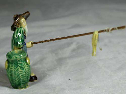 Mud Men - Old man fishing next to a large green barrel