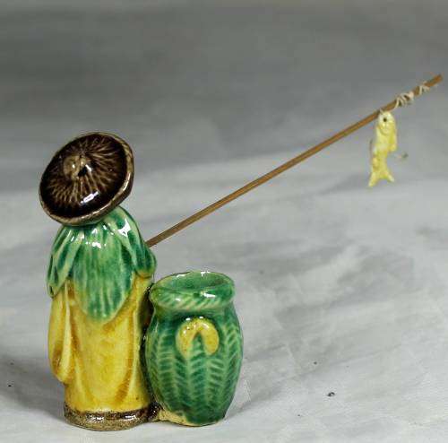 Mud Men - Old man fishing next to a large green barrel