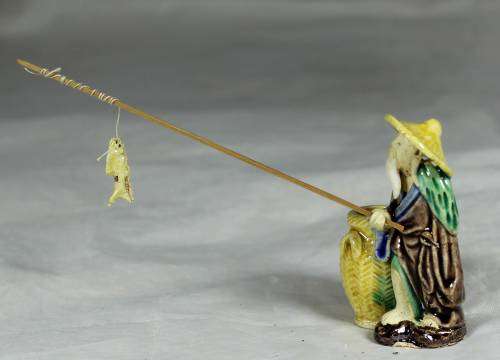 Mud Men - Old man fishing next to a large brown barrel