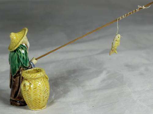 Mud Men - Old man fishing next to a large brown barrel