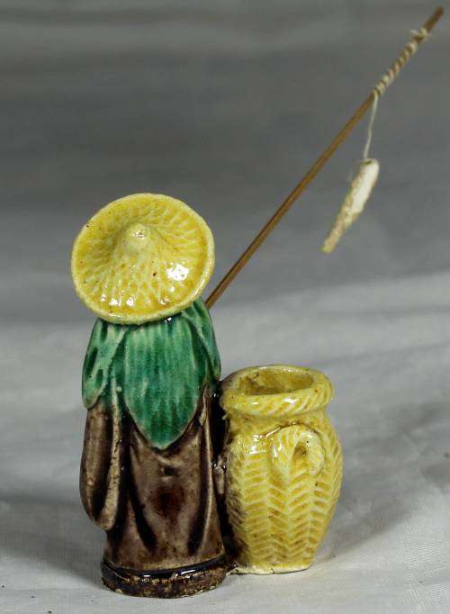 Mud Men - Old man fishing next to a large brown barrel