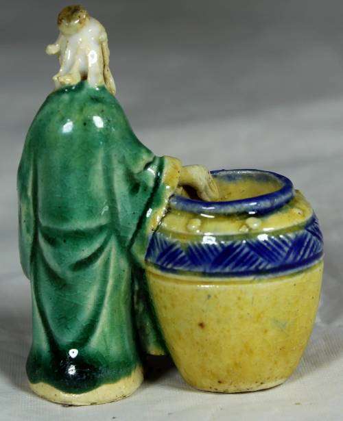 Mud men - old man holding onto a large barrel