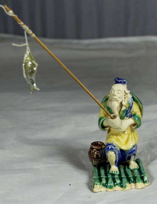 Mud Men - Old man fishing on a raft