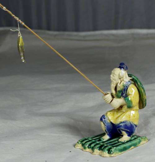 Mud Men - Old man fishing on a raft