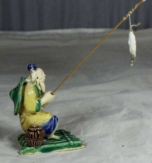 Mud Men - Old man fishing on a raft