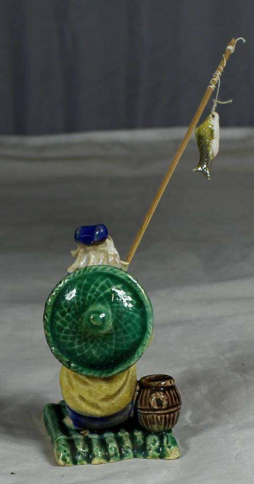 Mud Men - Old man fishing on a raft