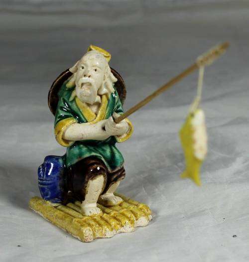 Mud Men - Old man fishing on a raft