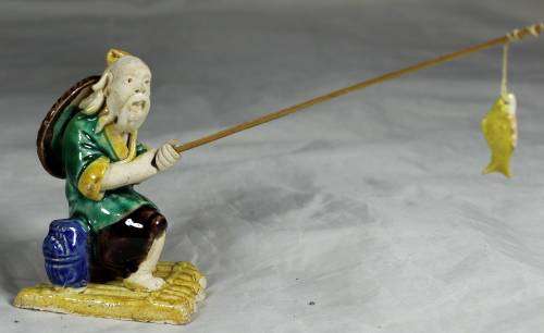 Mud Men - Old man fishing on a raft