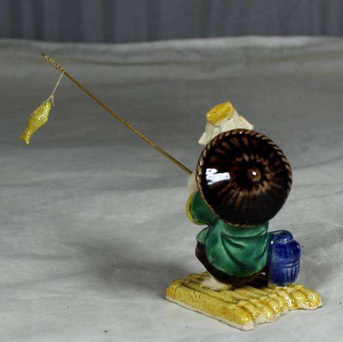 Mud Men - Old man fishing on a raft