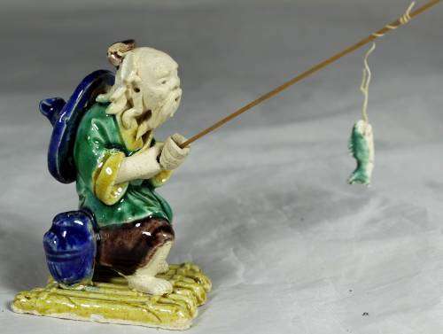 Mud Men - Old man fishing on a raft