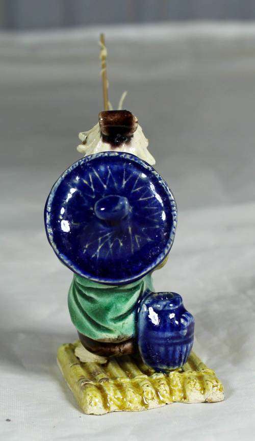 Mud Men - Old man fishing on a raft