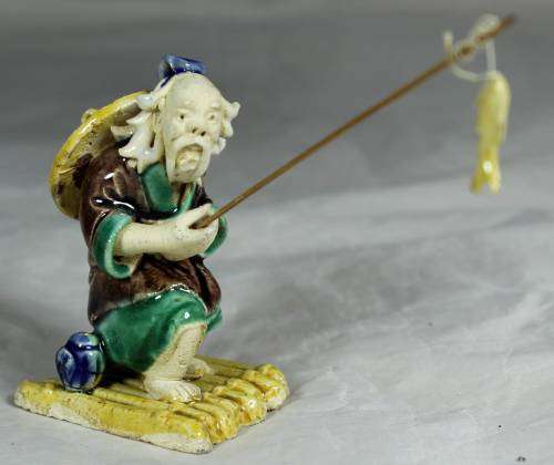 Mud Men - Old man fishing on a raft