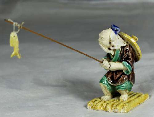 Mud Men - Old man fishing on a raft