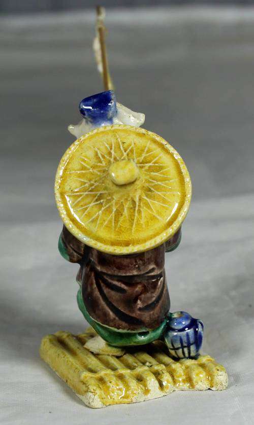 Mud Men - Old man fishing on a raft