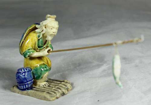 Mud Men - Old man fishing on a raft