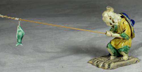 Mud Men - Old man fishing on a raft