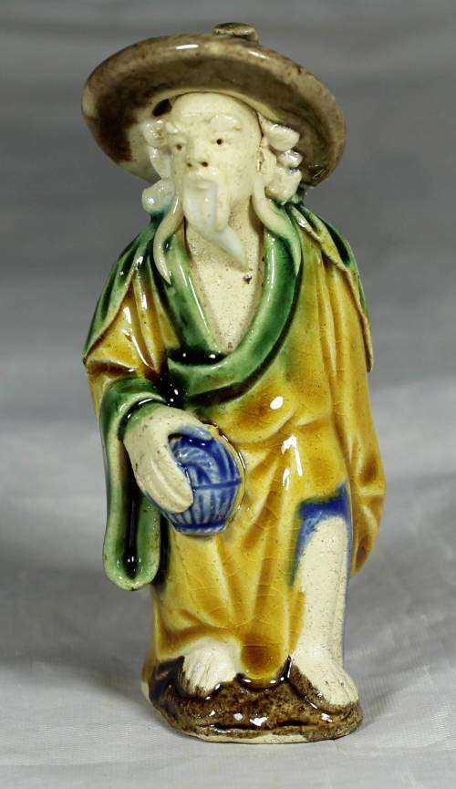 Mud men - old man holding a container