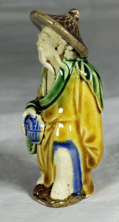 Mud men - old man holding a container