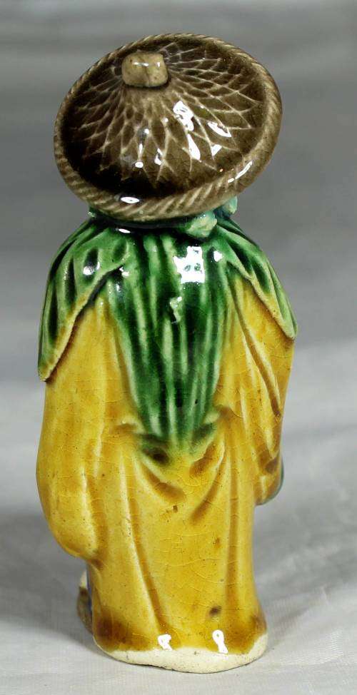 Mud men - old man holding a container