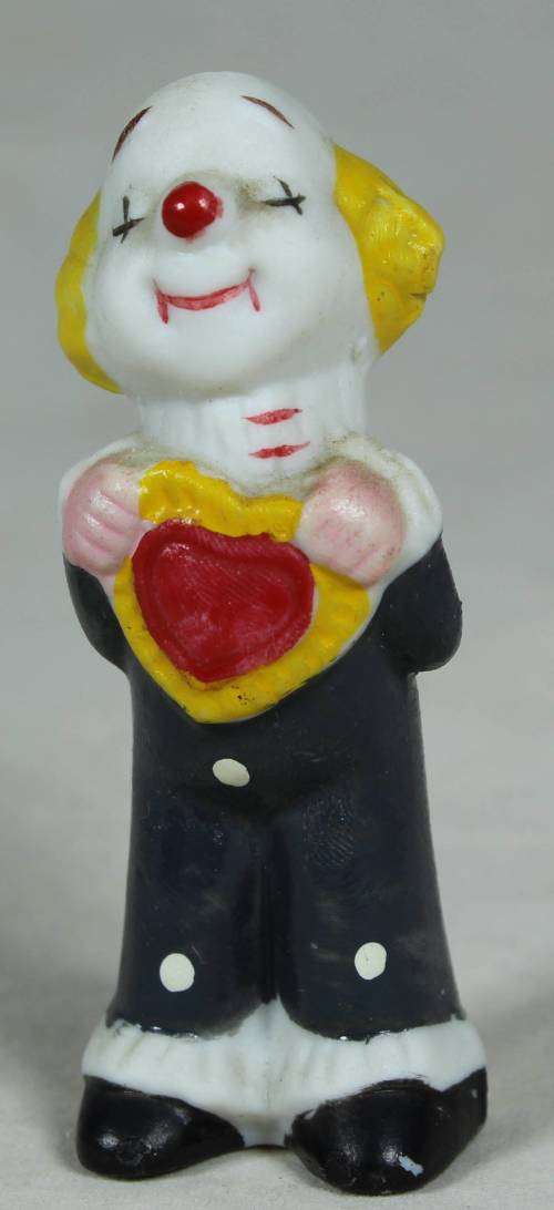 Miniature clown holding a red heart