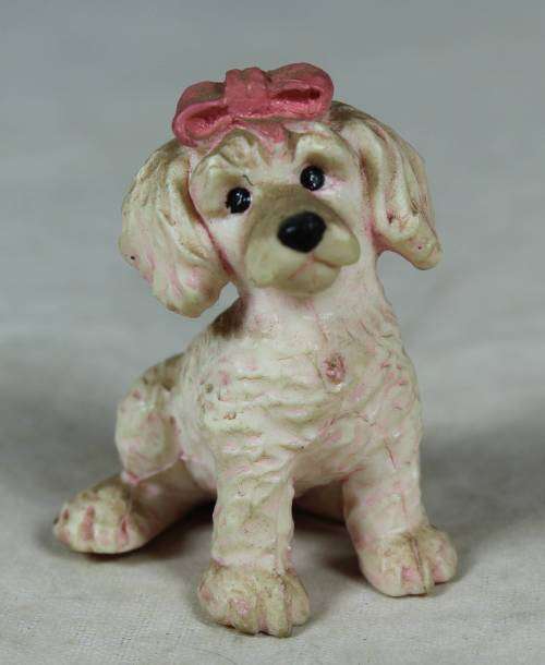 Miniature hardened plastic pink poodle