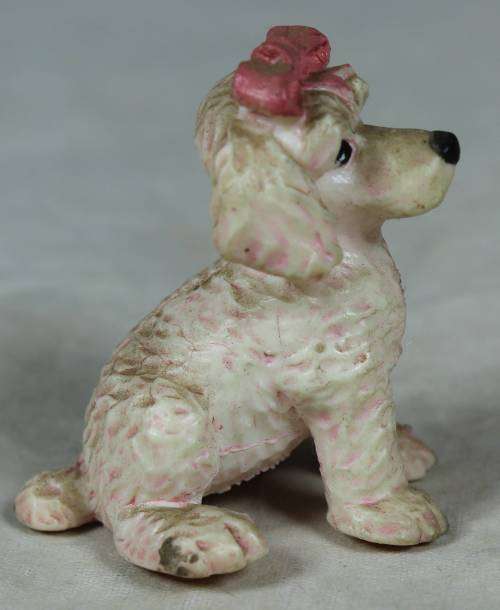 Miniature hardened plastic pink poodle