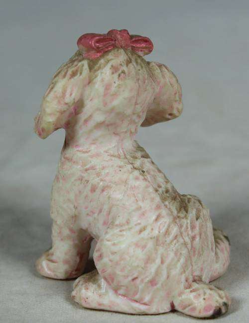 Miniature hardened plastic pink poodle