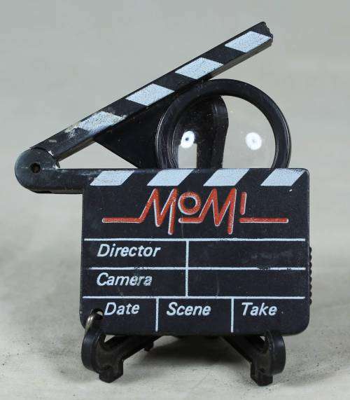 Miniature film clapper board with a magnifying glass
